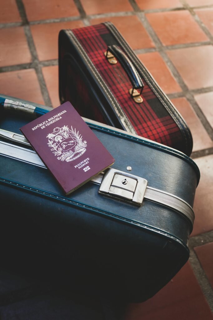 Venezuelan passport resting on vintage suitcases, ideal travel concept imagery for vacation and adventure themes.
